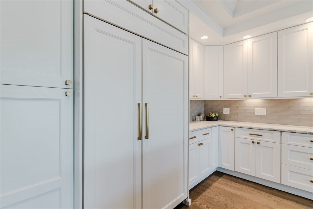 247 D Street, Unit 8 Boston, MA 02127 - Photo 18 of 42 a kitchen with white cabinets and white appliances