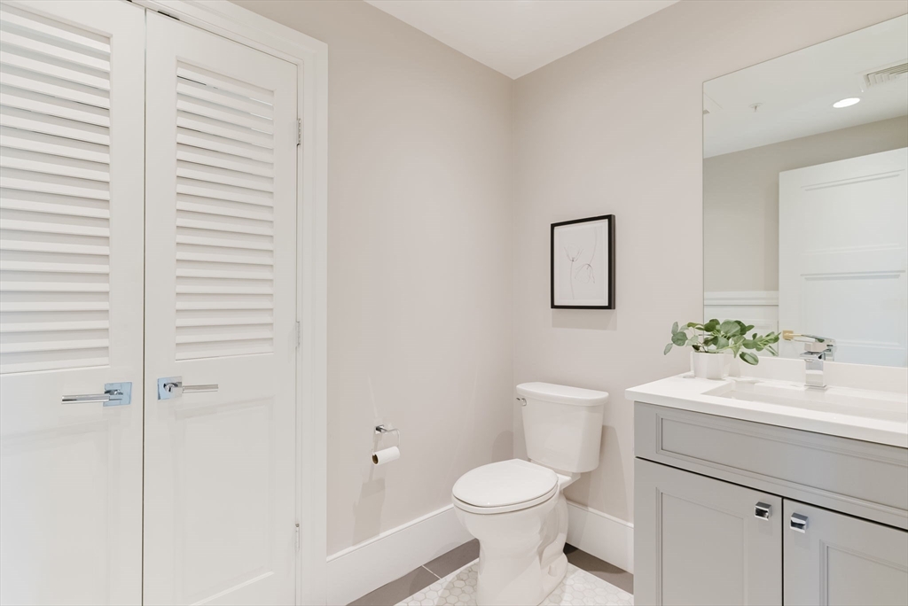 247 D Street, Unit 8 Boston, MA 02127 - Photo 19 of 42 a bathroom with a sink a toilet and vanity