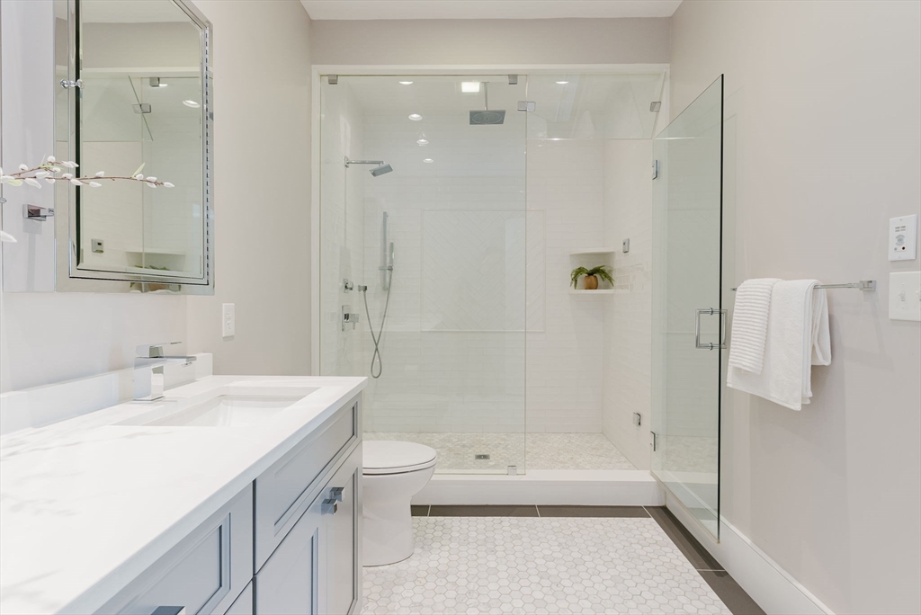 247 D Street, Unit 8 Boston, MA 02127 - Photo 24 of 42 a bathroom with a bathtub shower sink mirror and toilet