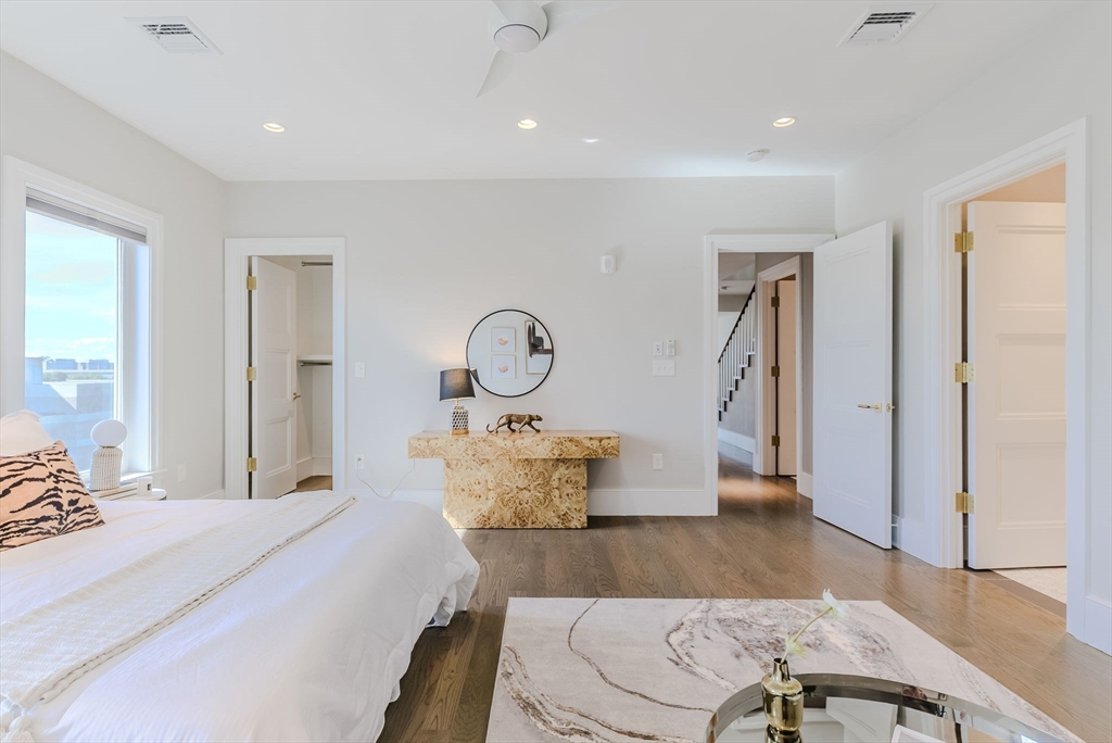 247 D Street, Unit 8 Boston, MA 02127 - Photo 33 of 42 a bedroom with a bed and wooden floor