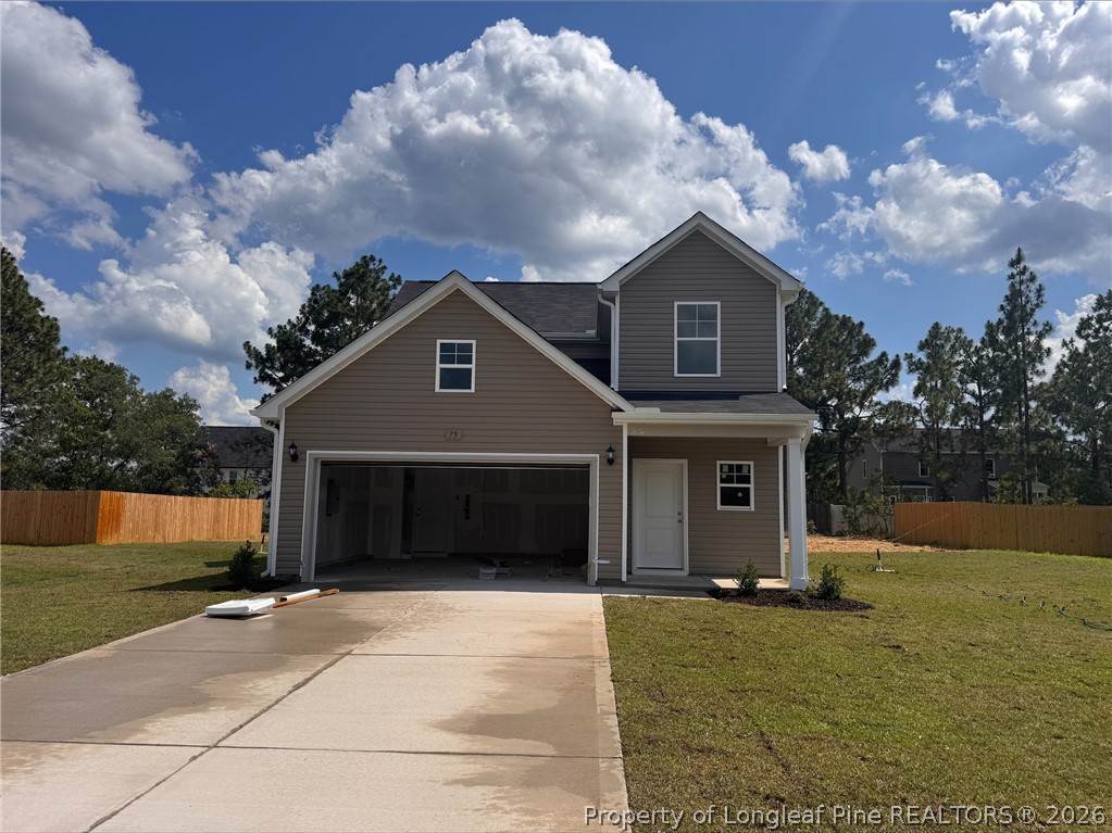 73 Utah Court Spring Lake, NC 28390 - Photo 1 of 4 a front view of a house with a yard and garage
