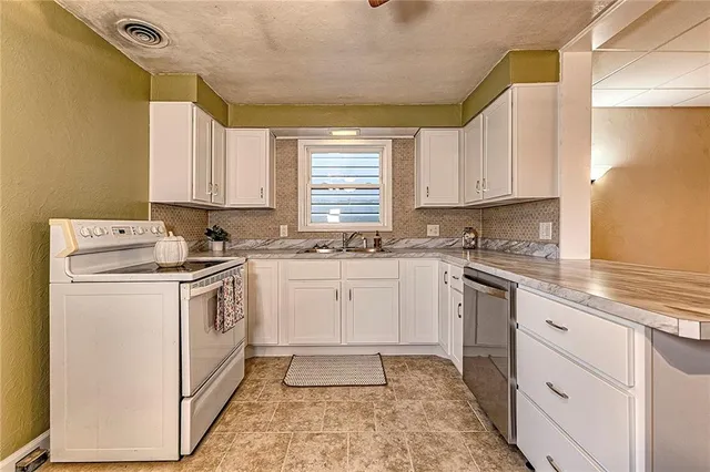 an empty room with closet and windows