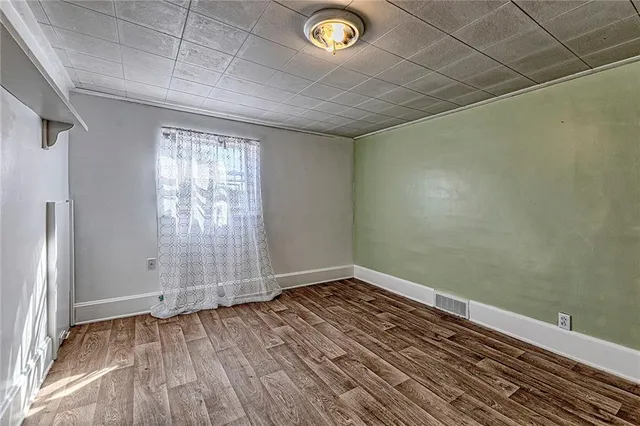 a view of a room with wooden floor