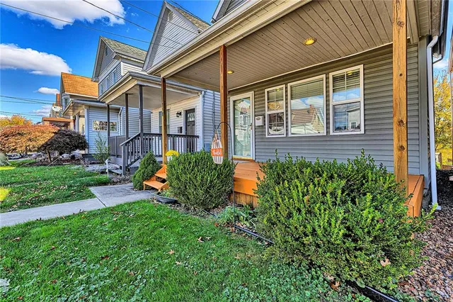 a view of a house with a yard and sitting area
