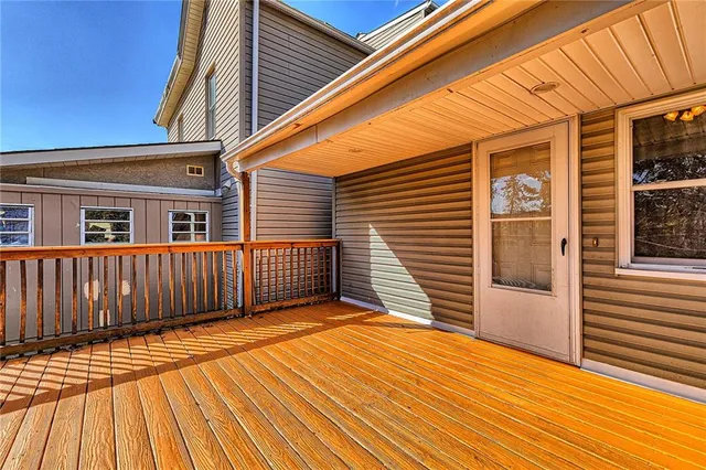a balcony with wooden floor and fence