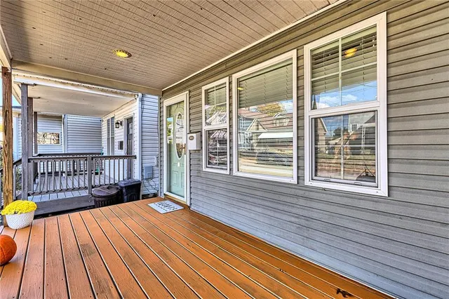 a view of an empty room with stairs and windows