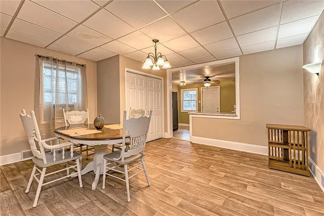 a view of a dining room with furniture and chandelier