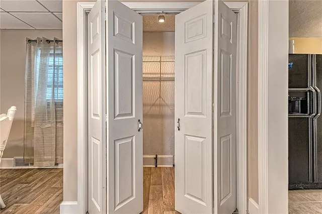 a kitchen with a white cabinets and window