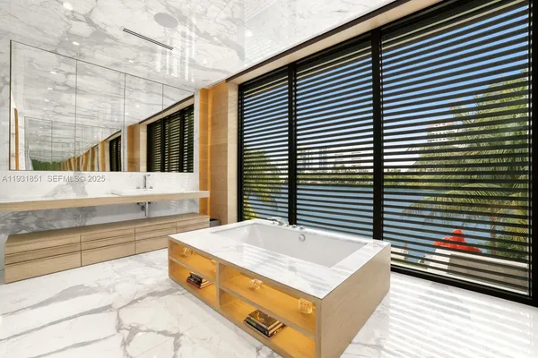 a bathroom with a bathtub and a sink shower