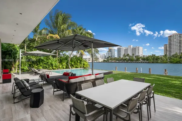 a view of a house with backyard porch and sitting area