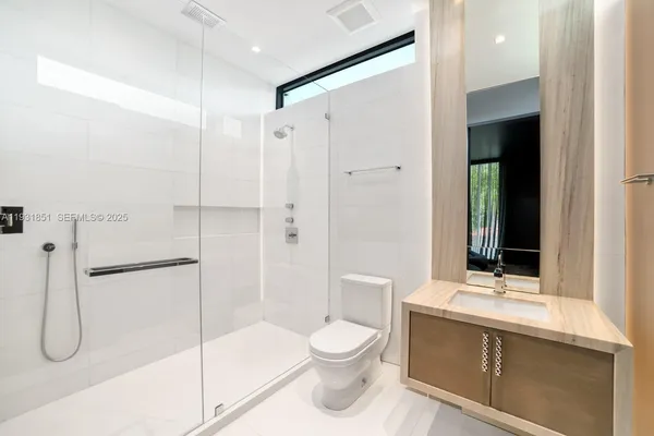 an aerial view of multiple houses with a lake view