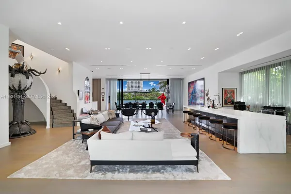 a living room with furniture flat screen tv and a table