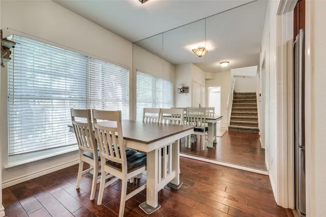 a dining room with furniture and wooden floor