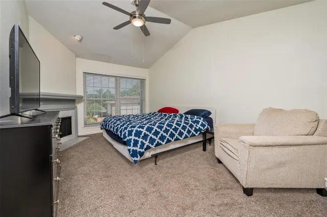 a bedroom with a bed rug and window