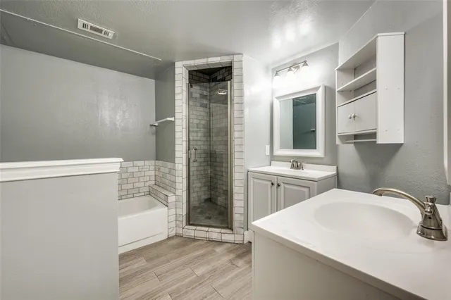 a bathroom with a sink a mirror and a shower