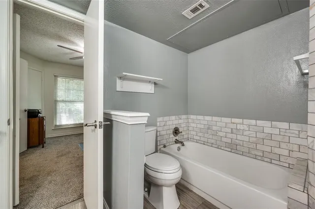 a bathroom with a toilet and a bathtub