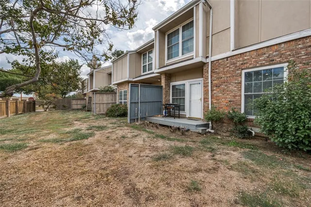 a view of a house with backyard porch and sitting area