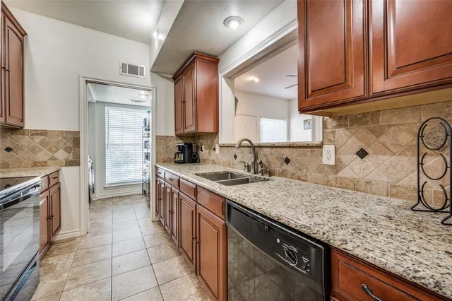 a kitchen with stainless steel appliances granite countertop a sink stove and cabinets