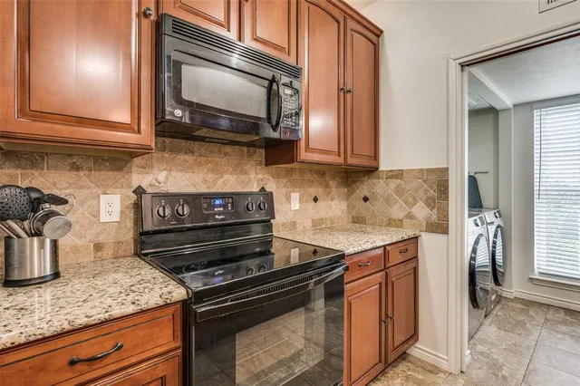 a kitchen with a stove and a microwave