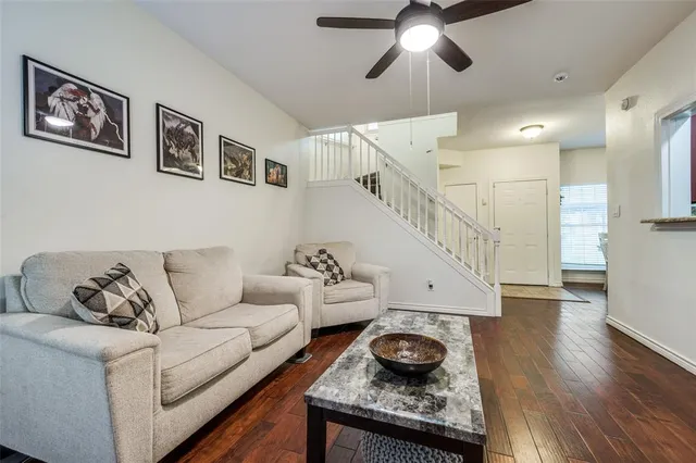 a living room with furniture and wooden floor