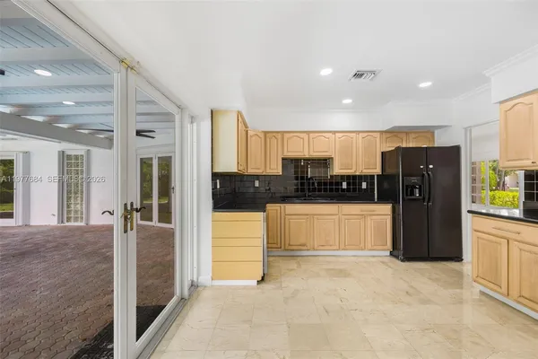 a kitchen with stainless steel appliances granite countertop a stove a sink and a refrigerator