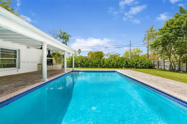 a view of swimming pool with a yard