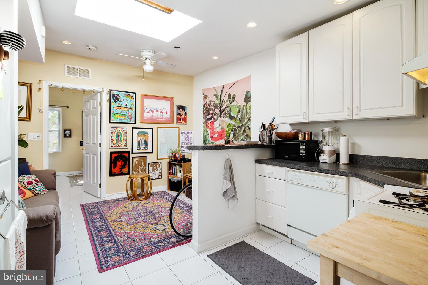 a kitchen with stainless steel appliances granite countertop a refrigerator sink and white cabinets