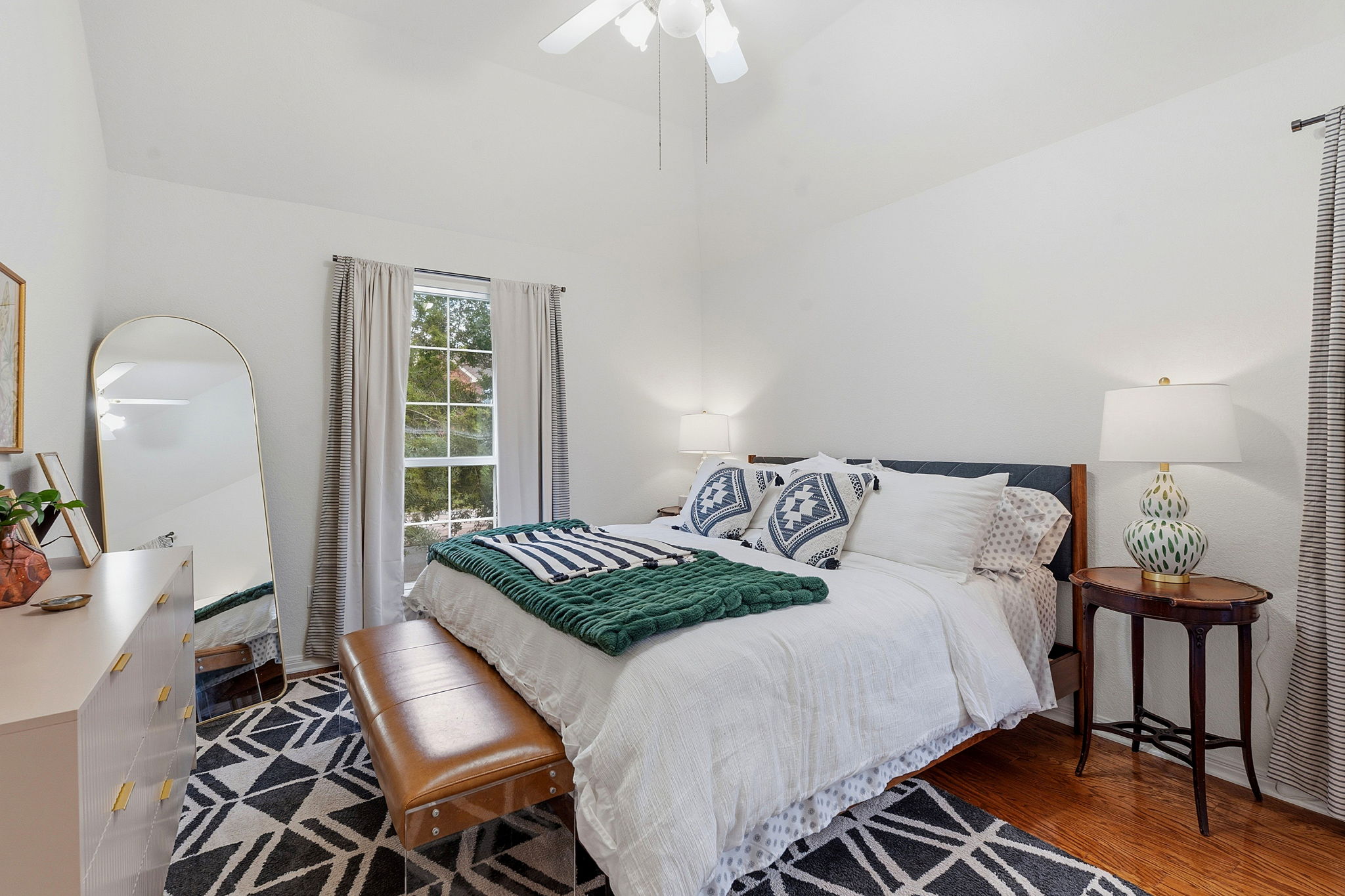 8317 Pommel Drive Austin, TX 78759 - Photo 19 of 26 Hardwood floors and a ceiling fan enhance this cozy bedroom with natural light.
