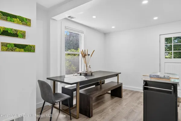 a room with table chair and window