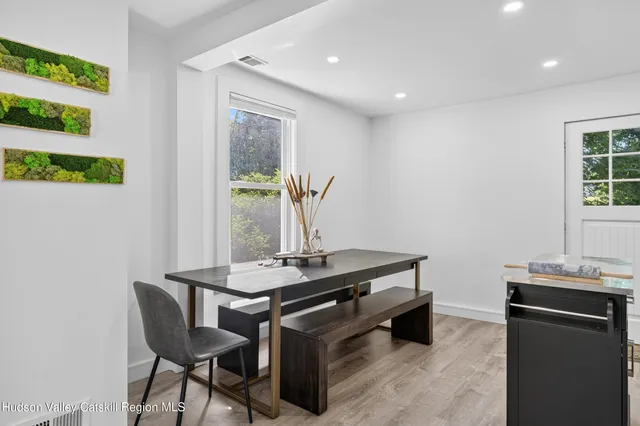 a room with table chair and window