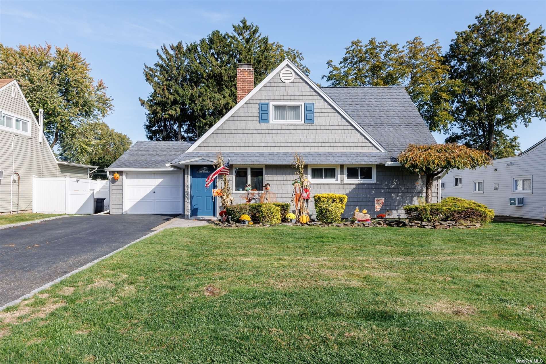 a view of a house with a yard and sitting area