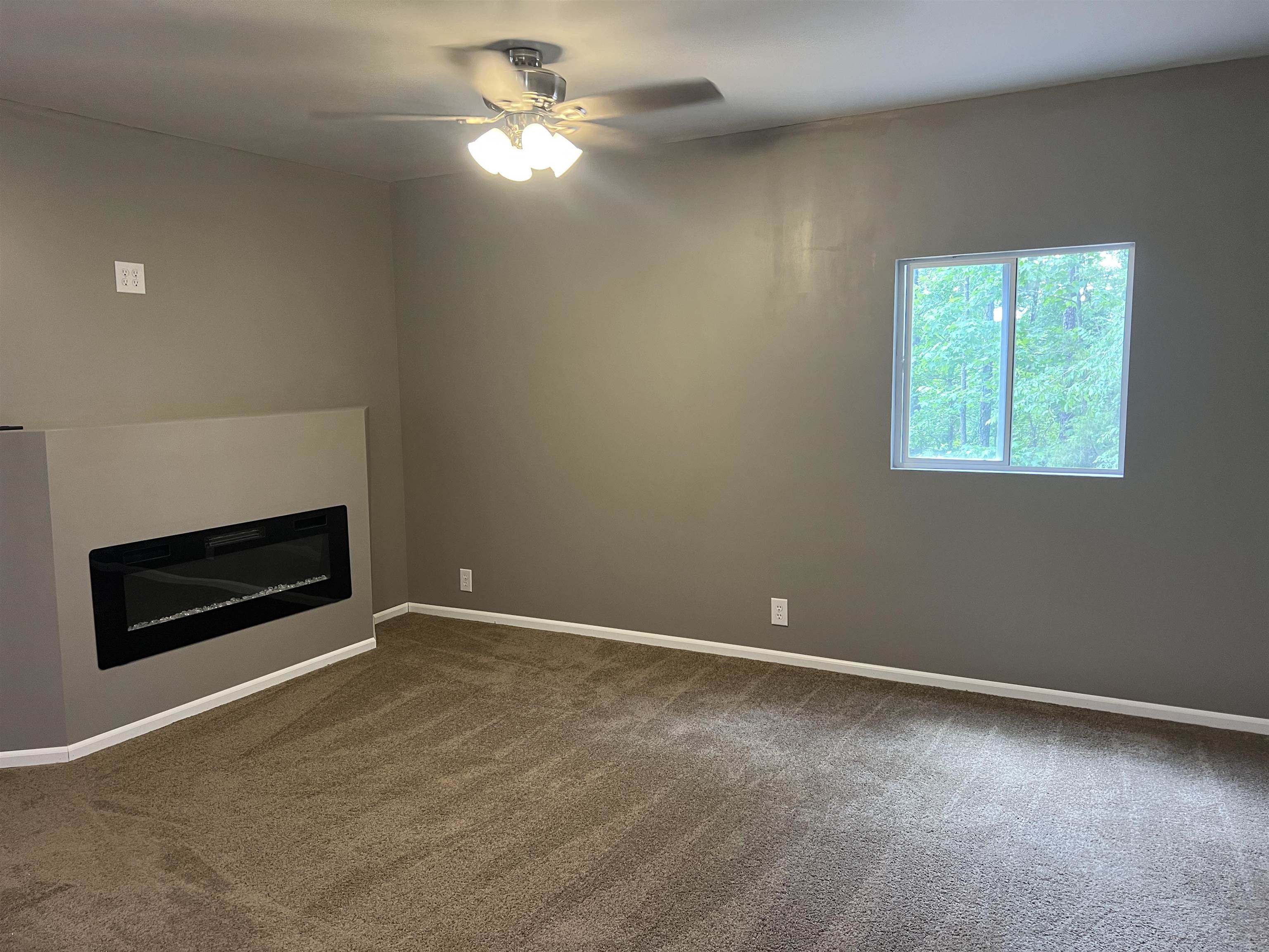1525 Bullman Road Finger, TN 38334 - Photo 4 of 24 an empty room with windows and fan