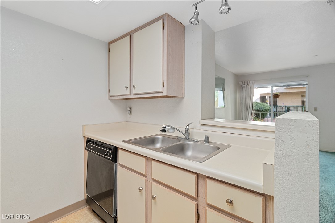 3550 Bay Sands Drive, Unit 1050 Laughlin, NV 89029 - Photo 12 of 71 Kitchen featuring light countertops, black dishwasher, and light brown cabinets