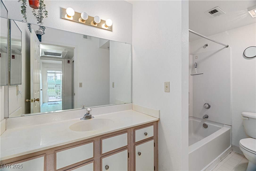 3550 Bay Sands Drive, Unit 1050 Laughlin, NV 89029 - Photo 19 of 71 Full bathroom featuring vanity, shower / tub combination, and light tile patterned floors, located directly across the hall from the Primary bedroom
