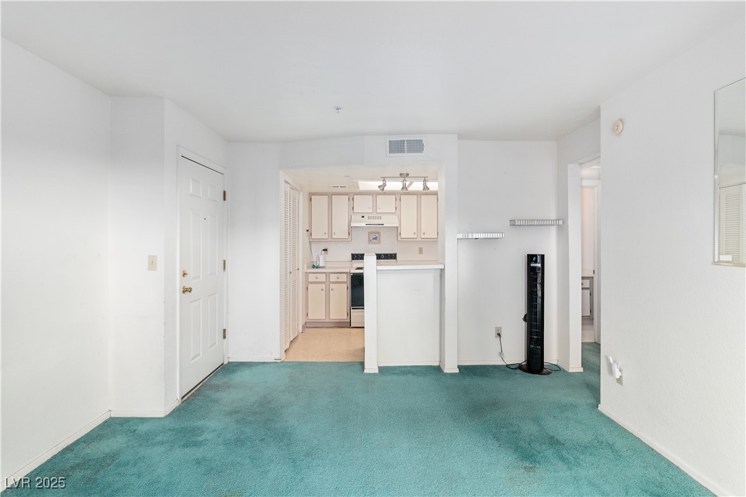 3550 Bay Sands Drive, Unit 1050 Laughlin, NV 89029 - Photo 8 of 71 Kitchen with light colored carpet, light countertops, and under cabinet range hood