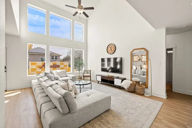 a living room with furniture a couch and a flat screen tv