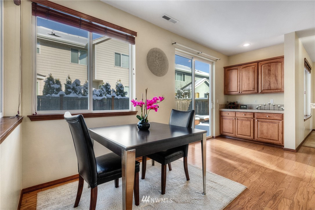 3219 172 Street Southeast Bothell, WA 98012 - Photo 8 of 25 a view of a dining room with furniture and wooden floor