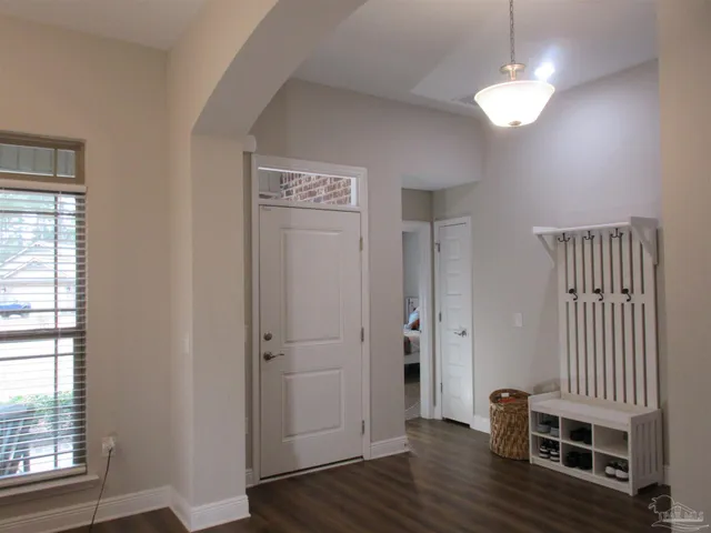 a bedroom with a large bed and a chandelier