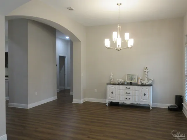 a bathroom with a granite countertop toilet and sink