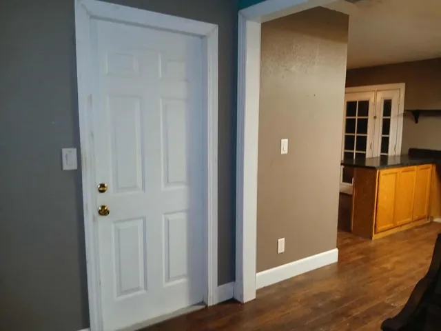 an empty room with wooden floor and closet