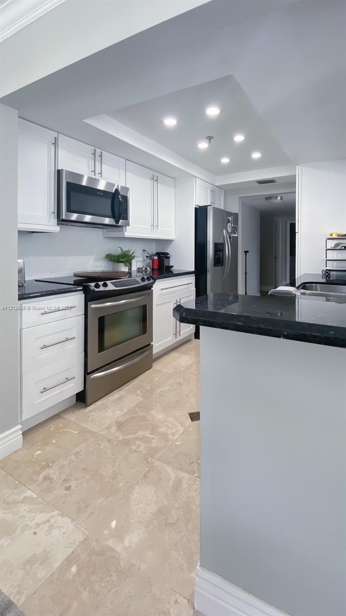 859 Jeffery Street, Unit 201 Boca Raton, FL 33487 - Photo 12 of 33 a kitchen with stainless steel appliances granite countertop a stove and a sink
