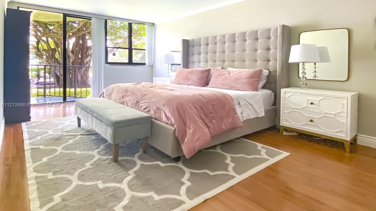 859 Jeffery Street, Unit 201 Boca Raton, FL 33487 - Photo 15 of 33 a bedroom with a bed and a lamp next to a window