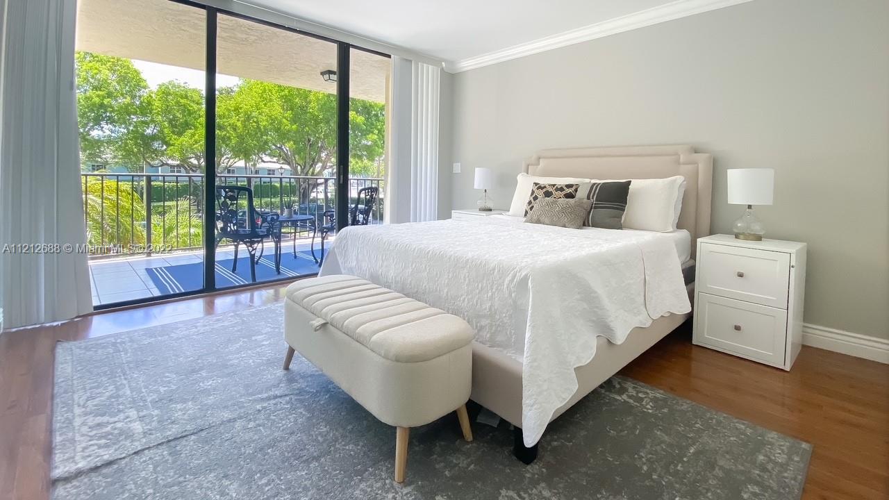 859 Jeffery Street, Unit 201 Boca Raton, FL 33487 - Photo 18 of 33 a bedroom with a bed and a large window