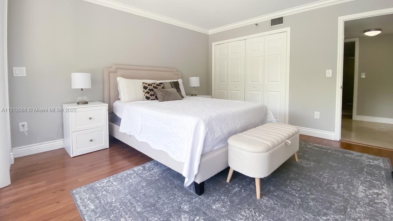 859 Jeffery Street, Unit 201 Boca Raton, FL 33487 - Photo 19 of 33 a bedroom with a bed and a night stand