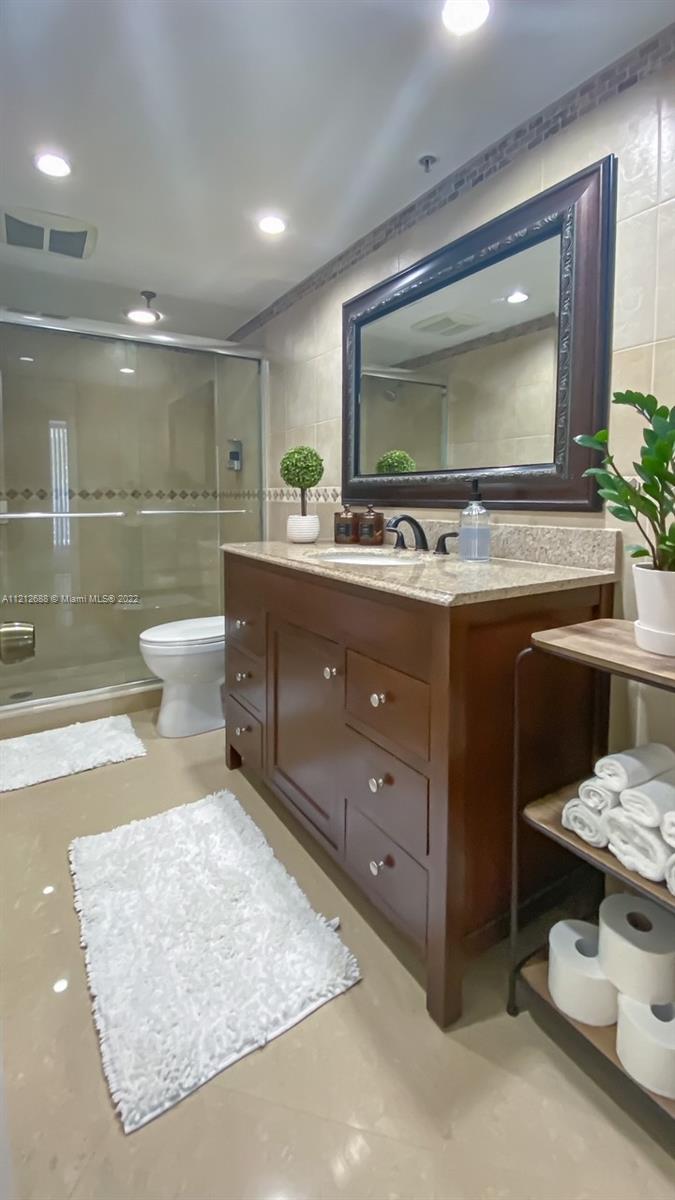 859 Jeffery Street, Unit 201 Boca Raton, FL 33487 - Photo 20 of 33 a living room with a couch and a flat screen tv