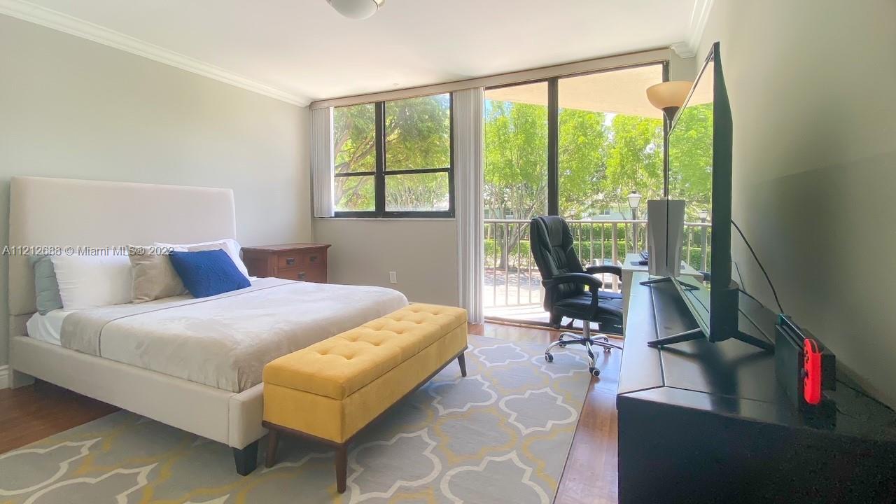 859 Jeffery Street, Unit 201 Boca Raton, FL 33487 - Photo 21 of 33 a bedroom with a bed and a large window