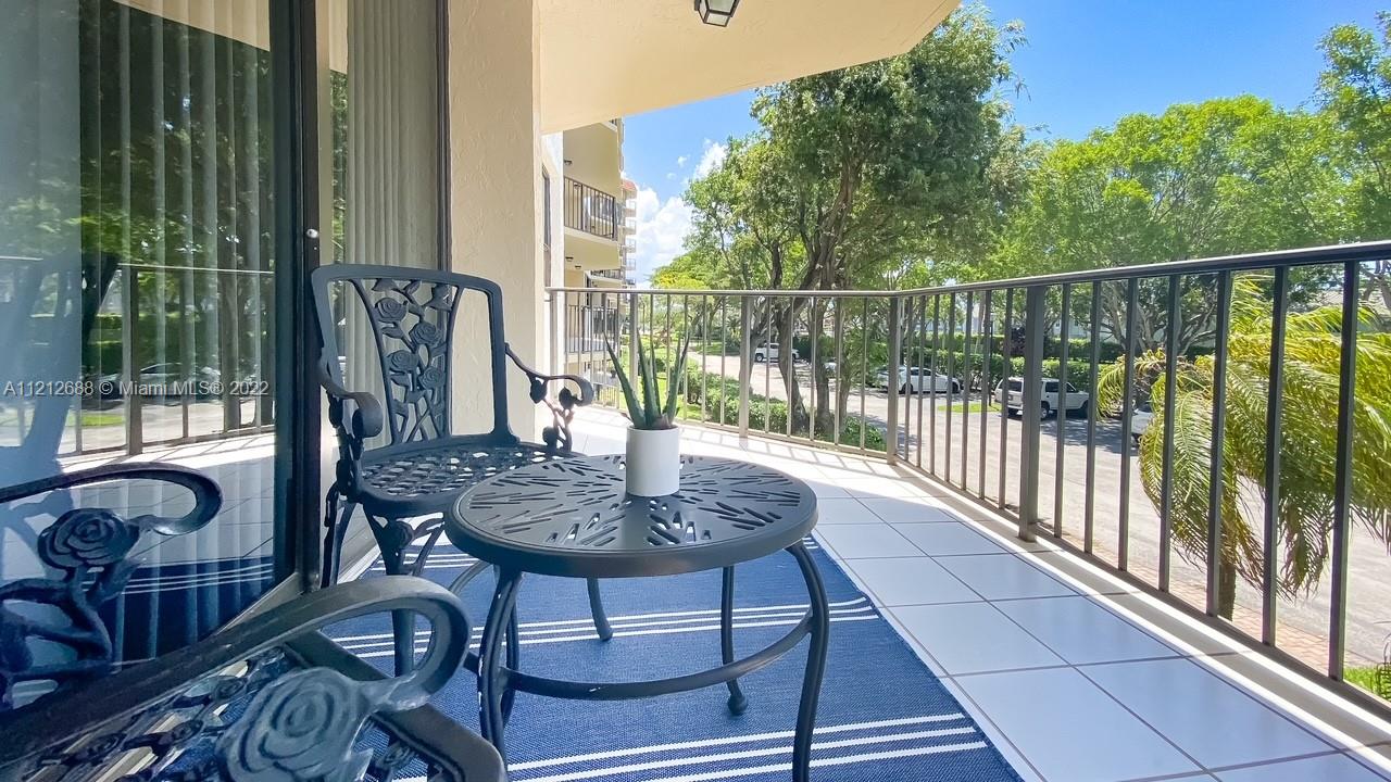 859 Jeffery Street, Unit 201 Boca Raton, FL 33487 - Photo 25 of 33 a view of balcony with wooden floor and outdoor seating