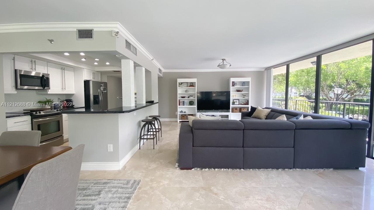 859 Jeffery Street, Unit 201 Boca Raton, FL 33487 - Photo 9 of 33 a living room with furniture and a flat screen tv