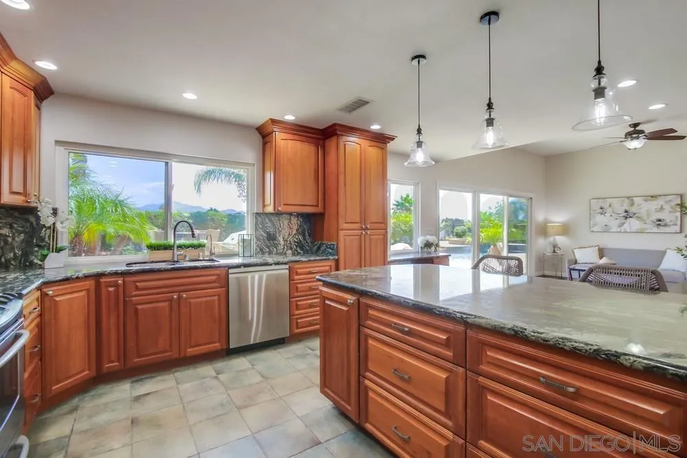 14747 Dash Way Poway, CA 92064 - Photo 17 of 65 a kitchen with stainless steel appliances granite countertop a sink a counter space and a window