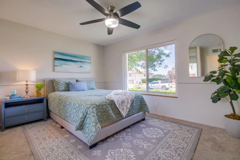 14747 Dash Way Poway, CA 92064 - Photo 23 of 65 a bedroom with a large bed and a potted plant